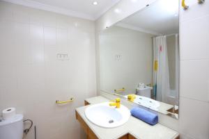 biała łazienka z umywalką i lustrem w obiekcie Chalet Adosado zona med/baja w mieście Sierra Nevada +10 zdjęć