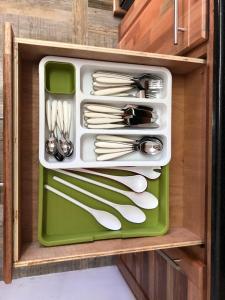 a drawer filled with utensils in a cabinet at Kays Residence in Pereybere