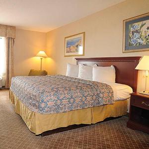 a hotel room with a large bed in a room at Days Inn by Wyndham Calumet Park in Calumet Park