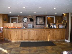 a large wooden bar in a room with a counter at Motel West in Idaho Falls