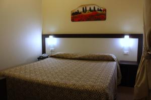 a bedroom with a bed and a picture on the wall at Hotel Boccascena in Genoa
