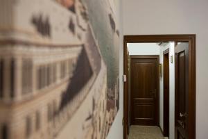 a hallway with a painting on the wall and a door at Venice Biennale in Venice