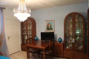 a dining room with a table and a chandelier at Morgana in Castrezatto