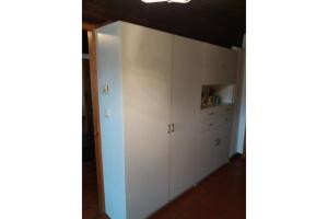 a kitchen with white cabinets in a room with a ceiling at Haus Forstamt in Stadtsteinach