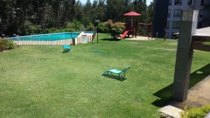 two chairs in a yard with a playground at Vista Laguna in San Pedro de la Paz +5 photos
