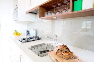 a kitchen counter with a loaf of bread on a cutting board at Lilypad Luxury Cabins in Bellingen