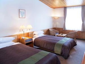 Postel nebo postele na pokoji v ubytování Kibi Kogen Resort Hotel + 21 fotografií