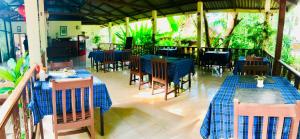 a restaurant with tables and chairs with blue tablecloths at N.T. Lanta Resort in Ko Lanta