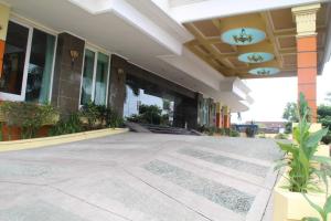 a building with a walkway in front of it at Mega Bintang Sweet Hotel in Cepu