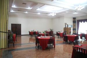 a dining room with red tables and chairs at Mega Bintang Sweet Hotel in Cepu