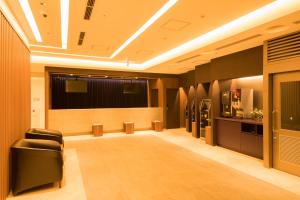 a conference room with chairs and refrigerators in it at Dormy Inn Matsuyama Natural Hot Spring in Matsuyama +64 photos