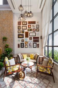 a living room with couches and a table at Maison De Camille Boutique Hotel in Ho Chi Minh City