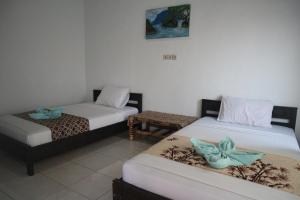 Postel nebo postele na pokoji v ubytování Syifa Homestay