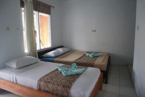 Postel nebo postele na pokoji v ubytování Syifa Homestay