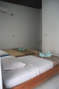 Postel nebo postele na pokoji v ubytování Syifa Homestay