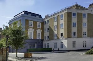 two buildings next to each other on a street at Best Western Plus Vauxhall Hotel in London