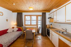 a kitchen with a couch and a table in a room at Haus Mühle in Sankt Gallenkirch