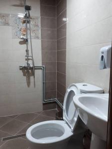 a bathroom with a toilet and a sink at Hotel Panorama city in Delčevo