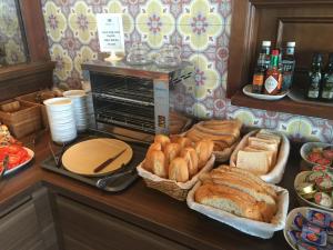 a buffet with bread and sandwiches on a counter at Toboso Apar - Turis in Nerja