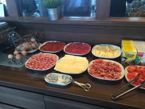 a buffet with many different types of cheeses and meats at Toboso Apar - Turis in Nerja