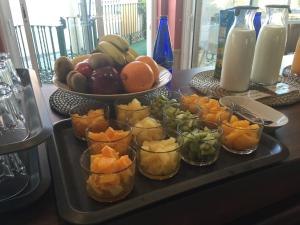 a tray of fruit in glass cups on a table at Toboso Apar - Turis in Nerja