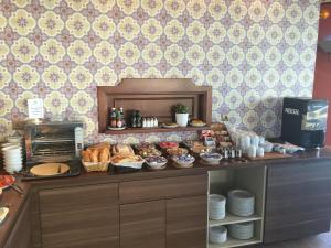 a buffet with bread and pastries on a counter at Toboso Apar - Turis in Nerja