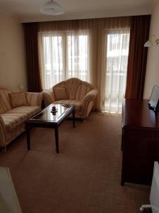 a living room with a couch and a coffee table at Apartment in Downtown Complex Bansko in Bansko