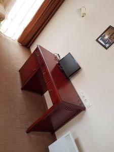 a table with a tv on top of a wall at Apartment in Downtown Complex Bansko in Bansko