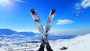 a pair of skis are standing in the snow at Saint Michel Chalets in Al Arz