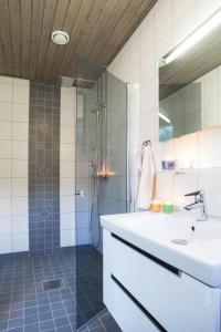 a bathroom with a sink and a shower at Villa Seaview Guesthouse & Spa in Teijo