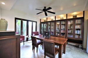 a dining room with a table and chairs and a ceiling fan at The Quarter Pai in Pai