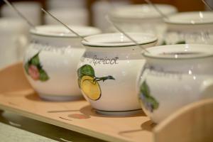 a row of white bowls sitting on a shelf at Posthotel Mayrhofen in Mayrhofen