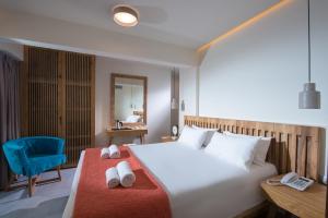 a hotel room with a large bed and a large window at Harma Boutique Hotel in Hersonissos