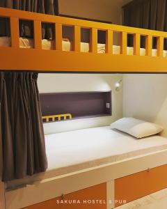 a bunk bed with a white mattress on it at Sakura Suit Hostel in Fethiye