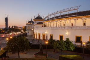 a large white building with a street in front of it at River House in Seville