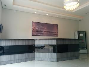 a large painting on the wall of a baggage claim at Hotel Artisan in Jaguarão