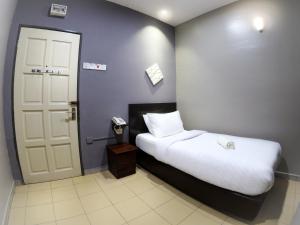 Postel nebo postele na pokoji v ubytování JV Hotel @ Bandar Tasek Mutiara