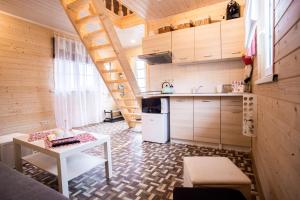 a small kitchen with a table and a stove at Baltic Dream Vasarnamiai in Šventoji