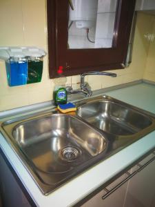 a stainless steel sink in a small kitchen at Holidays Domus Iano in Esparraguera
