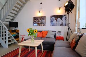 a living room filled with furniture and flowers at Pawlansky Apartments in Prague