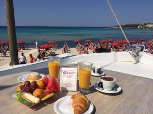 a tray of food and drinks on a table near the beach at Le Terrazze B&B in Pulsano