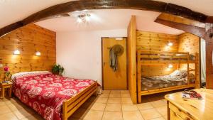 a bedroom with a bed and a bunk bed at Hotel restaurant Le Chamois in Ancelle