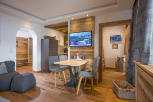 a kitchen and dining room with a table and chairs at Haus Central in Kössen