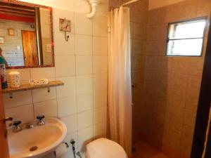 a bathroom with a sink and a toilet and a shower at Aire del Cerro in Capilla del Monte +13 photos