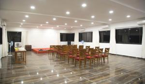 a large room with a long table and chairs at Hotel Arambol Arbour in Arambol