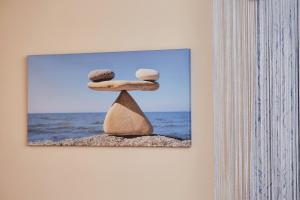 a picture of two rocks on a wall at Art Hotel in Surgut