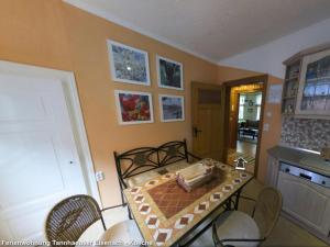 a room with a table and chairs and a kitchen at Ferienwohnungen Ender in Eisenach