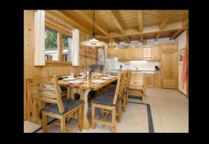 a dining room with a wooden table and chairs at Chalet Clochette 4 Valles-Verbier in La Tzoumaz