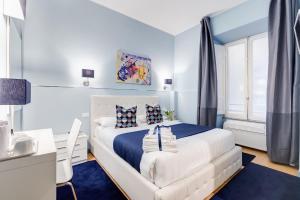 a bedroom with a white bed and a desk at Easy Budget Colosseo in Rome