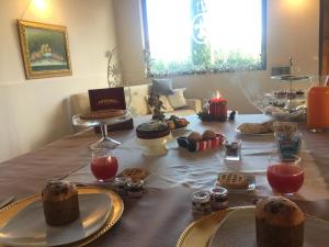 a table with cakes and cookies and candles on it at Villa Simitode in Cava deʼ Tirreni